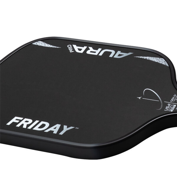 Corner view of the black Friday Aura Pro paddle, showing white "FRIDAY" logo and "AURA PRO" text with speckles.