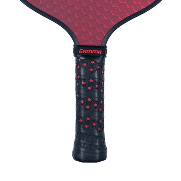 Close-up of a black pickleball paddle grip with red hexagonal pattern and GAMMA logo.