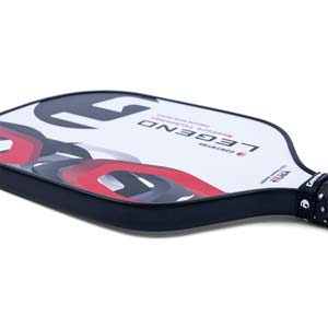 Side view of a white GAMMA Legend pickleball paddle with red and black abstract graphics and a black grip.