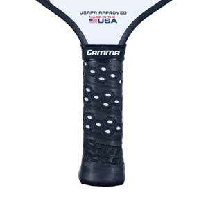 Close-up of a black pickleball paddle grip with hexagonal pattern and GAMMA branding.