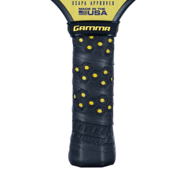 Close-up of a black pickleball paddle grip with yellow hexagonal pattern and GAMMA logo.