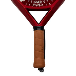 Close-up of the handle and neck of a red padel racket, showing the "GAMMA PADEL" logo and a brown grip.