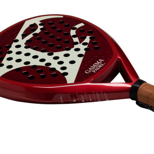 Side view of a red padel racket with a white abstract design, black holes, and "GAMMA PADEL" text.