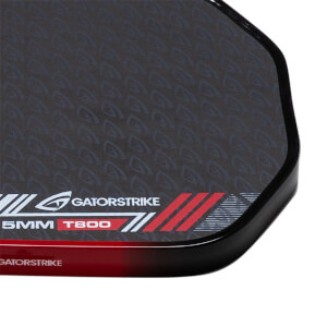 Close-up of a black pickleball paddle corner showing GatorStrike branding, 15MM T800 text, and a textured face pattern.