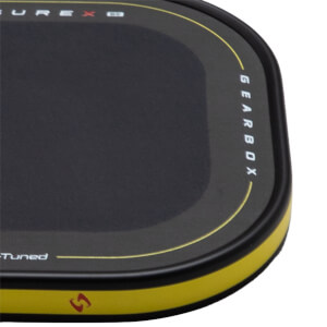 Top-down view of a black product with yellow trim, showing "GEARBOX" text and a red logo.