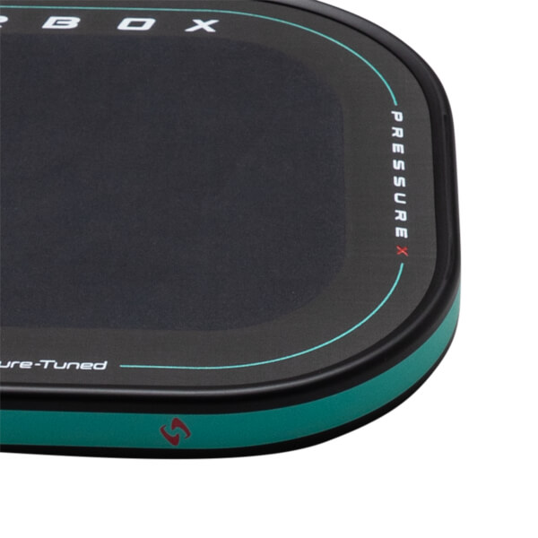 Corner view of a black product with white text "PRESSURE X" and "ure-Tuned" and a teal accent stripe.