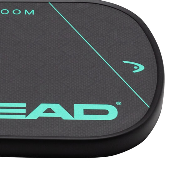 Close-up view of the corner of a black paddle with "HEAD" and a teal logo.