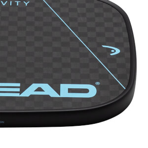 Corner view of a black pickleball paddle with a checkered pattern, a blue HEAD logo, and a blue diagonal line.