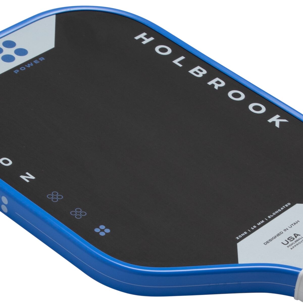 Angled top-down close-up of a black pickleball paddle with a blue edge guard, featuring HOLBROOK, ZONE, and POWER printed in white.