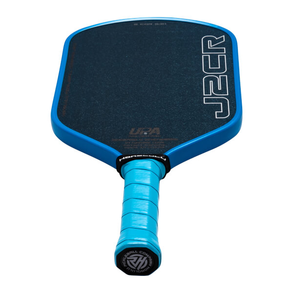 Bottom-up view from the handle looking at a black paddle face with white J2CR text, a bright blue frame and grip, and the Honolulu Pickleball Company logo on the end cap.