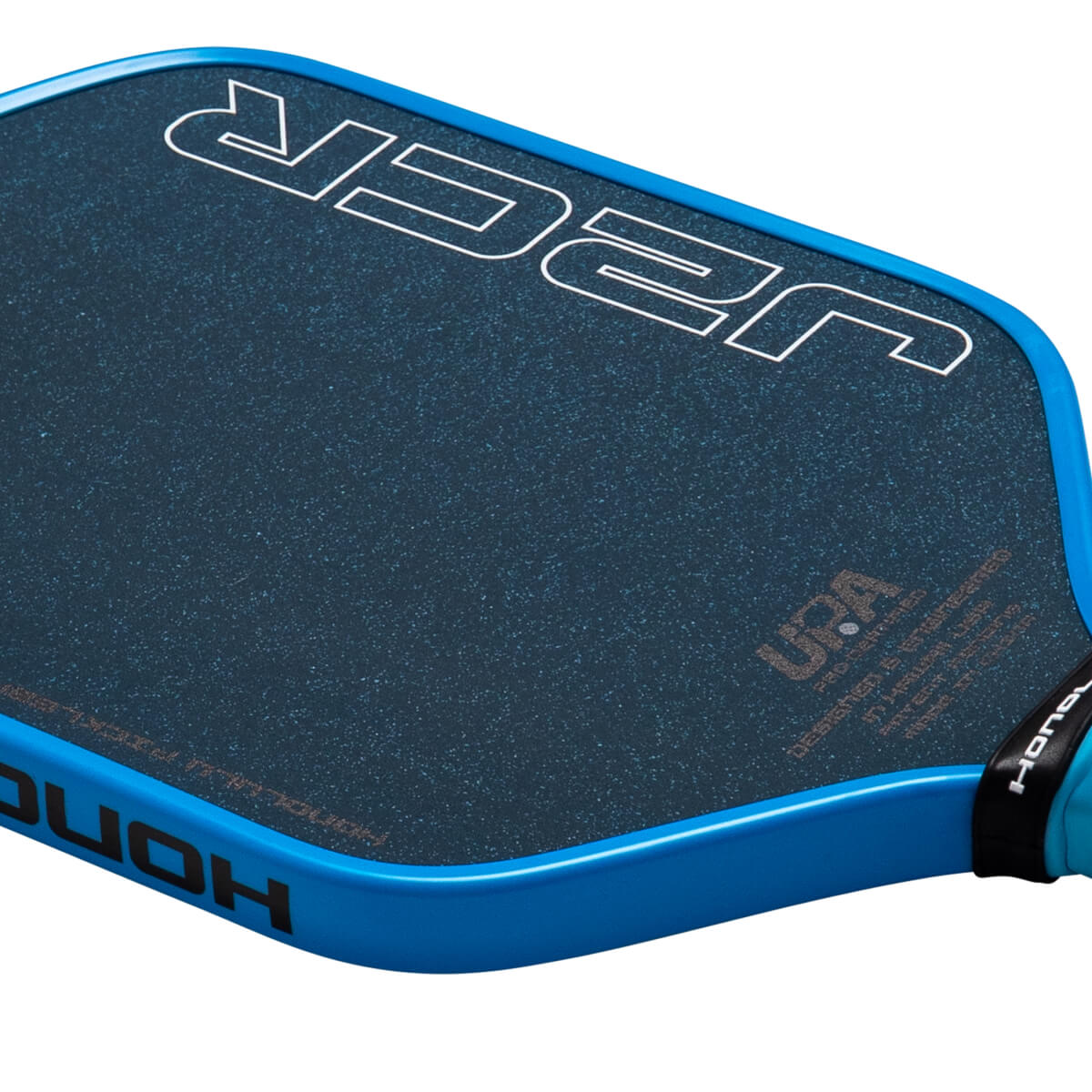 Close-up angled view of a pickleball paddle with a blue edge, "HONOLULU" branding, and a dark textured face featuring large white "J2K" outlines and a "UPA" logo.
