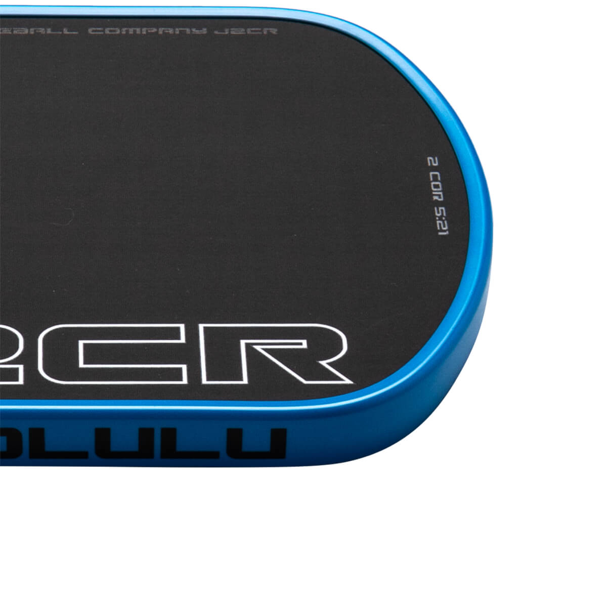 Corner view of a black product with a blue edge, showing "BALL COMPANY J2CR" and "2 COR 5:21".