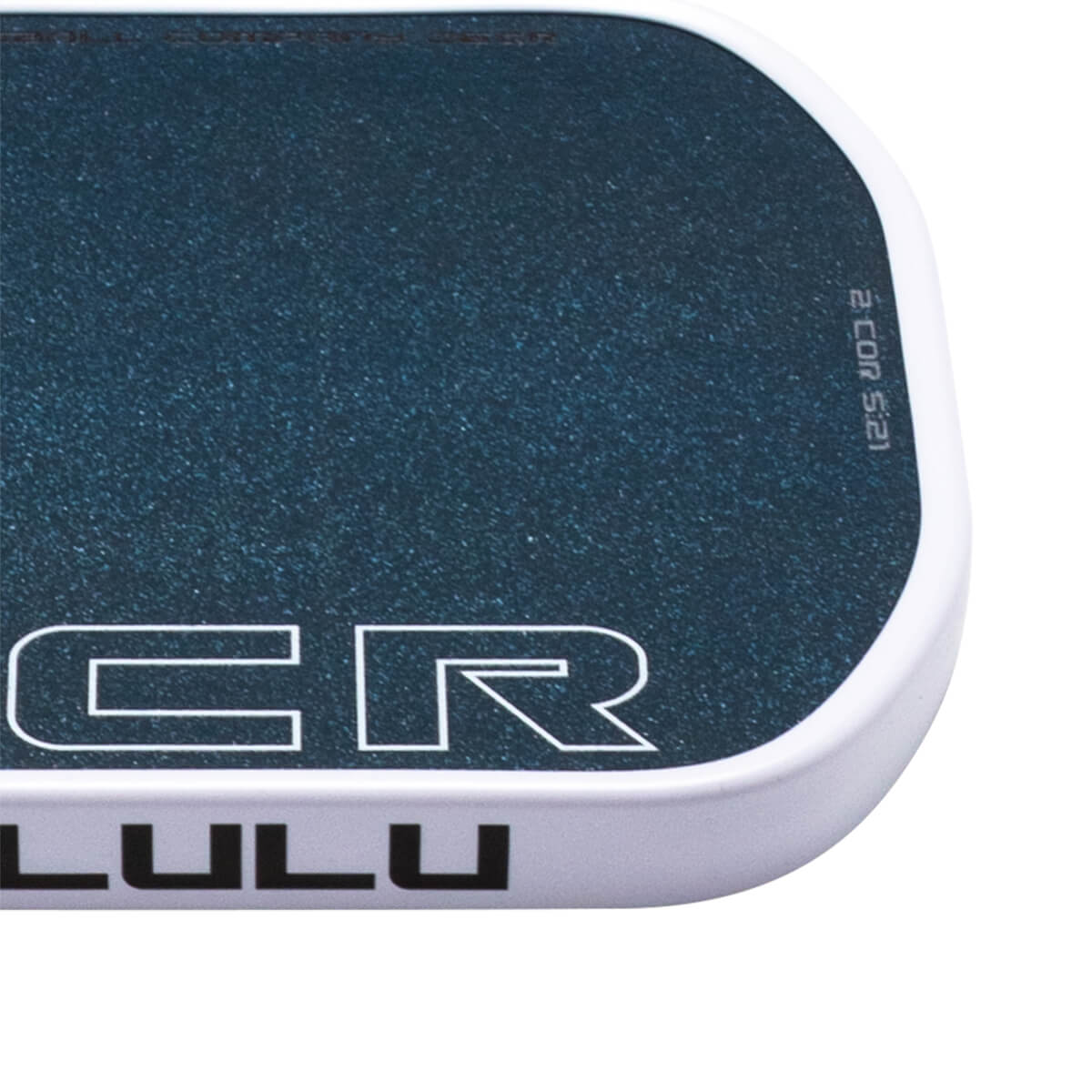 Corner view of a dark blue speckled surface with white text reading "CR LULU" and "2 COR 5:21".
