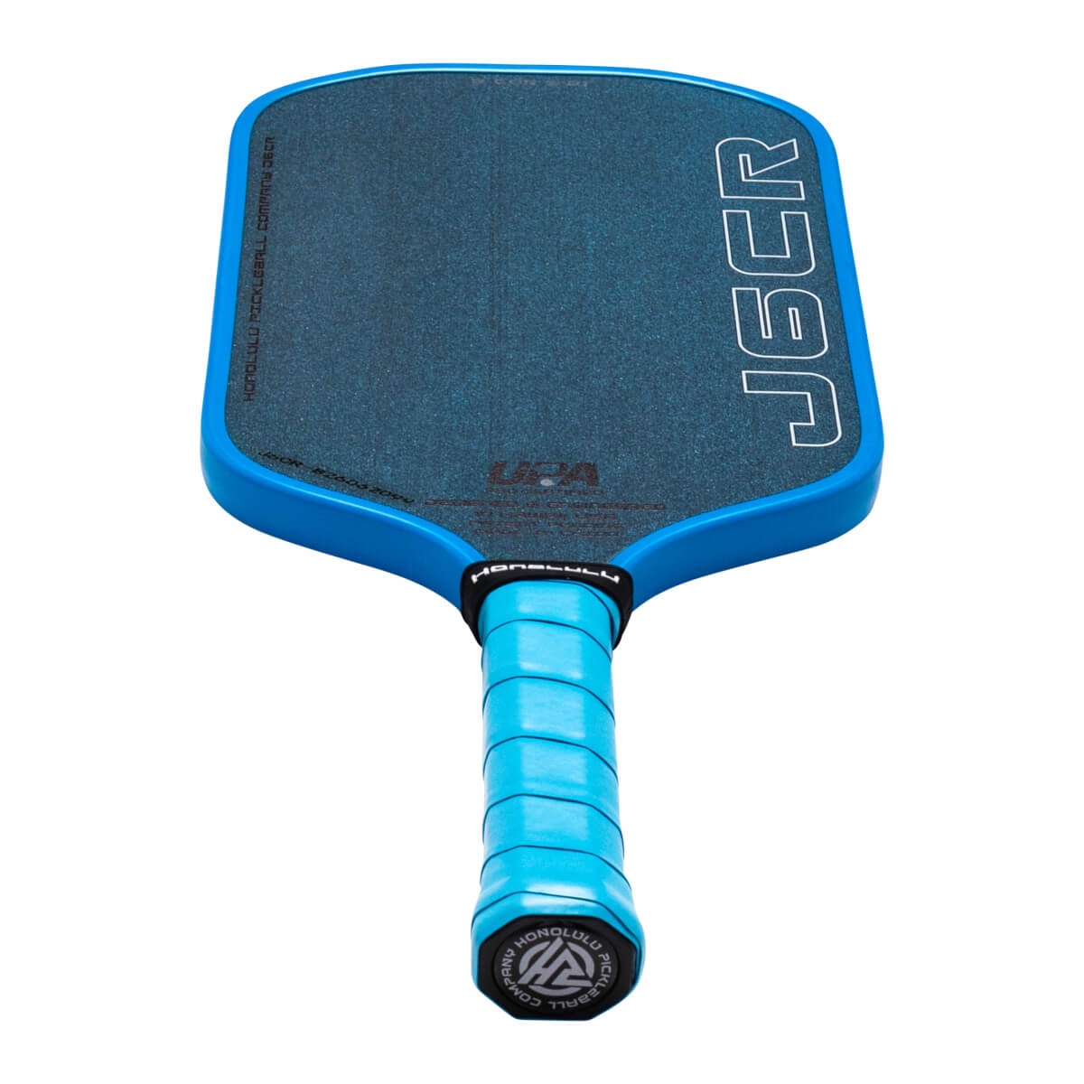 Top-down view of a blue pickleball paddle with "J6CR" and "HONOLULU PICKLEBALL COMPANY" visible.