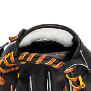 Close-up of the inside of a black baseball glove, showing white padding and brown and yellow lacing.