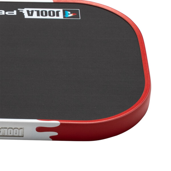 Corner view of a black paddle with a red edge and "JOOLA" logo.