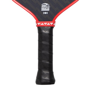 Close-up of a black pickleball paddle handle with a textured grip, red throat trim, and USA Pickleball approval logo.