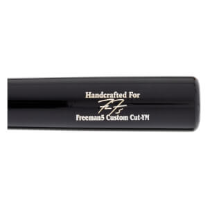 Close-up of a black baseball bat with gold Handcrafted For, a signature, and Freeman5 Custom Cut-YM text.