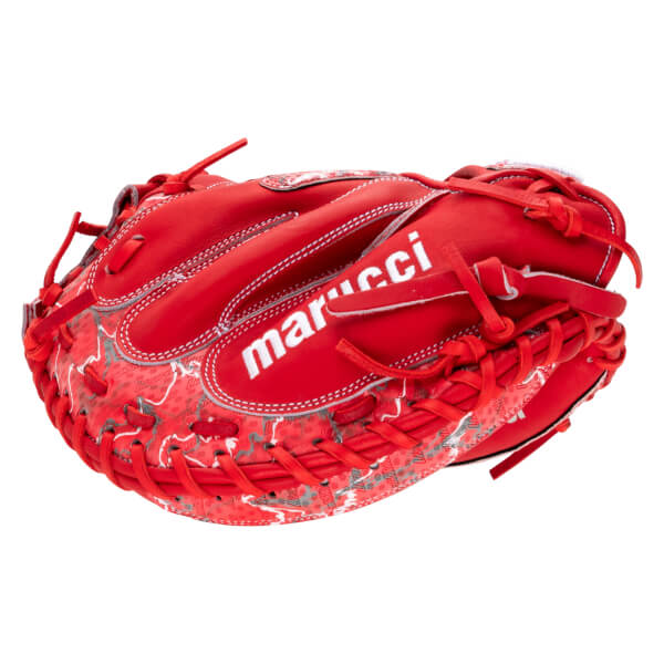 Back view of a red catcher’s mitt featuring the white "marucci" logo across a textured red and gray patterned shell with thick leather lacing.