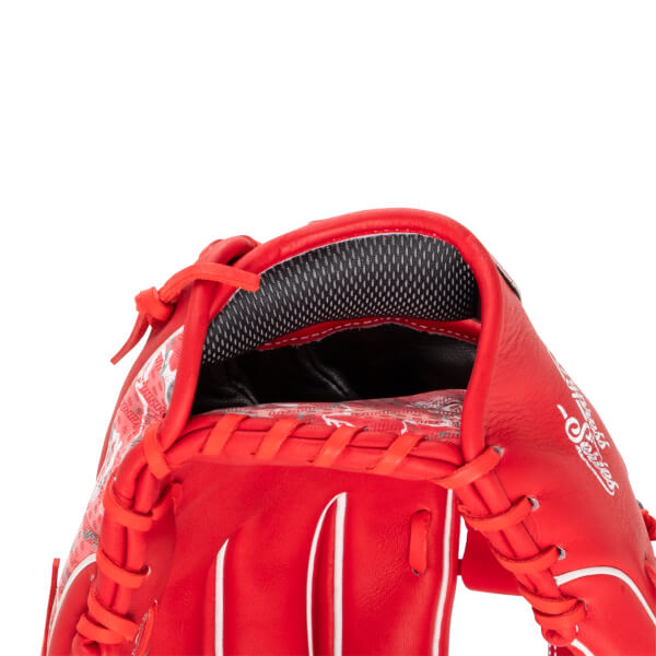 Close-up of the red baseball glove's hand opening reveals a grey mesh lining on the wrist strap and white "Series" script on the side.