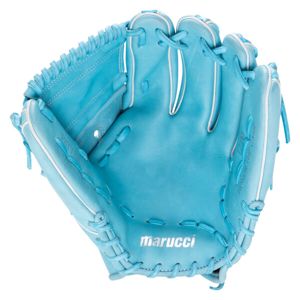 Front view of the light blue glove showing the palm with a silver marucci logo, white piping, and the words "HONOR THE GAME" and "12.00" stamped on the pinky.
