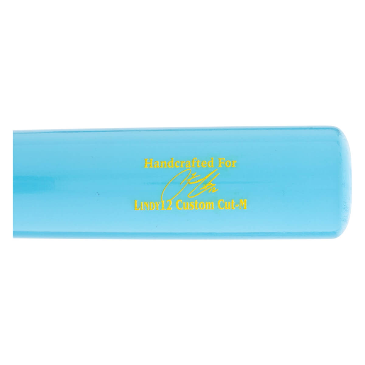 Close-up side view of a light blue baseball bat with yellow Handcrafted For text, a signature graphic, and LINDY12 Custom Cut-M printed on it.