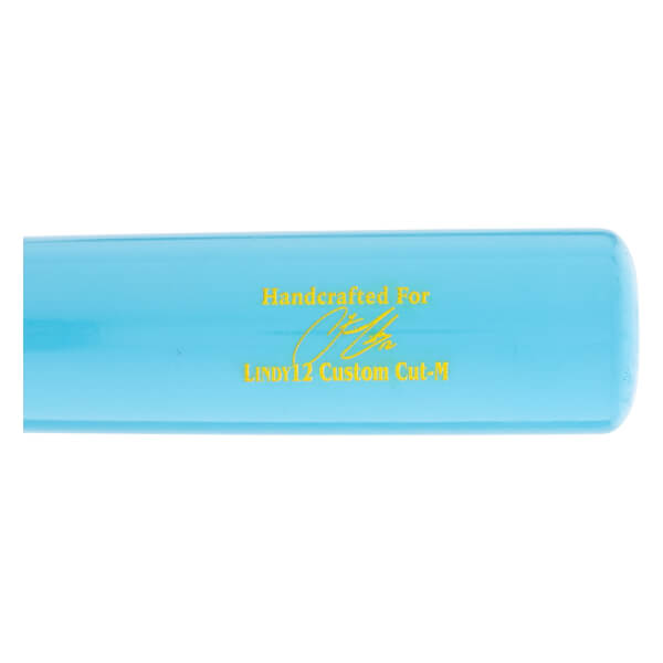 Close-up side view of a light blue baseball bat with yellow Handcrafted For text, a signature graphic, and LINDY12 Custom Cut-M printed on it.
