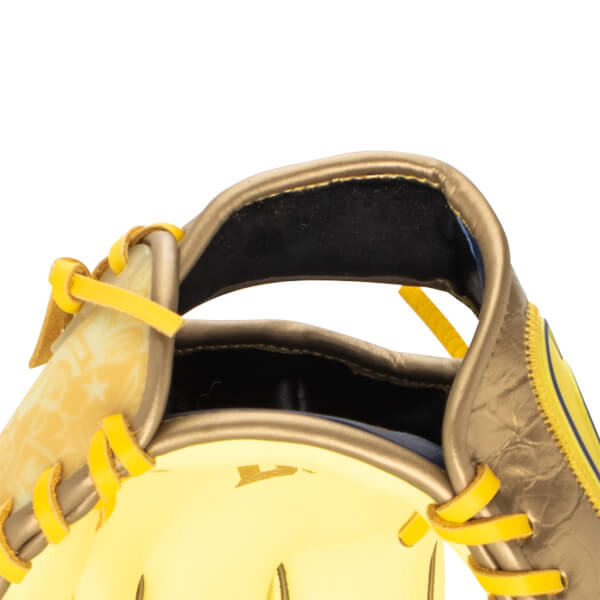 Close-up of a baseball glove showing yellow lacing, a gold exterior, and a star pattern on the palm.
