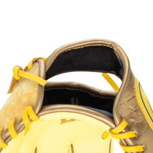 Close-up of a baseball glove showing yellow lacing, a gold exterior, and a star pattern on the palm.