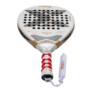Front view of a white Nox AT10 Genius Xtreme padel racket with a large gray X logo on the face, gold bridge accents, and a red and white textured grip.