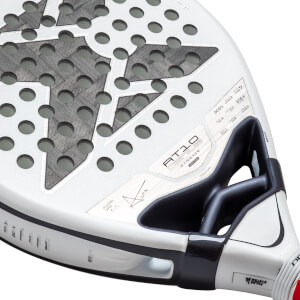 Close-up of a white NOX padel racket face showing the "AT10 GENIUS XTREME" text, a carbon fiber star pattern with circular holes, and a black aerodynamic bridge.