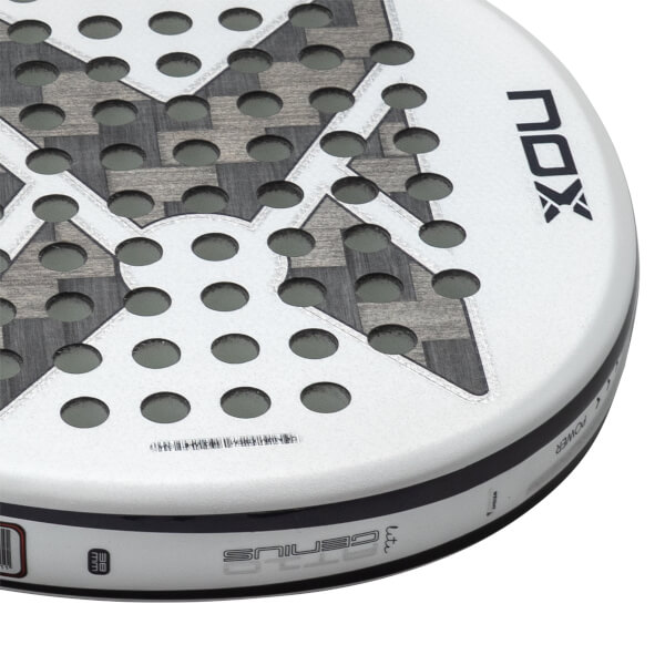Close-up angled view of a white NOX Genius padel racket head featuring circular holes, a carbon fiber X pattern, and prominent NOX and GENIUS branding.