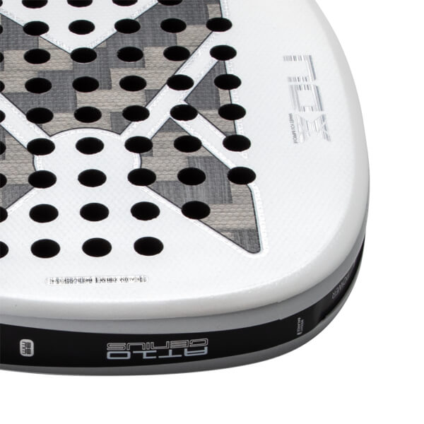 Close-up corner view of a white padel racket featuring a gray patterned 'X' over a perforated face with 'NOX' branding and 'AT10 GENIUS' text on the side edge.