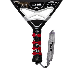 Close-up of a black padel racket with AT10 GENIUS on the face, a red and black grip, and silver NOX strap.