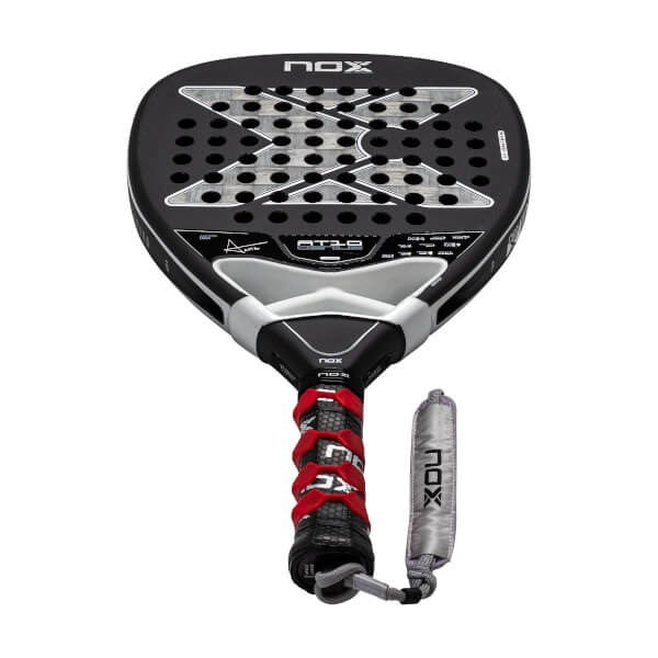 Front view of a black and silver padel racket with a perforated X pattern face, red overgrip, and NOX branding.