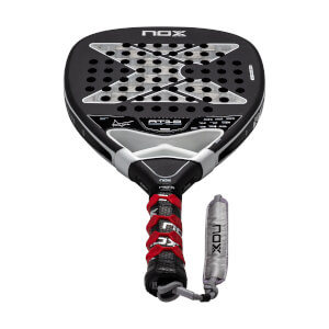 Front view of a black and silver padel racket with a perforated X pattern face, red overgrip, and NOX branding.