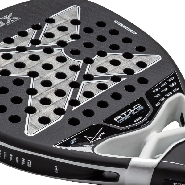 Close-up of a black and gray padel racket with a perforated face, textured carbon fiber pattern, and AT10 GENIUS branding.