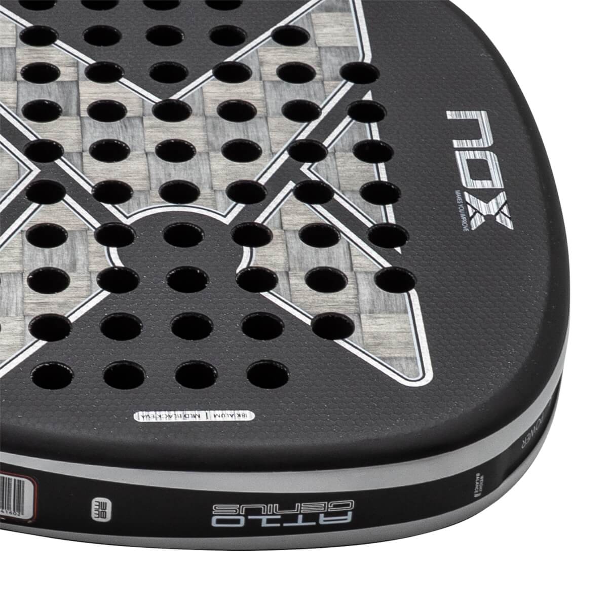 Close-up of a black padel racket with a grey woven carbon fiber face, NOX logo, and AT10 GENIUS on the edge.