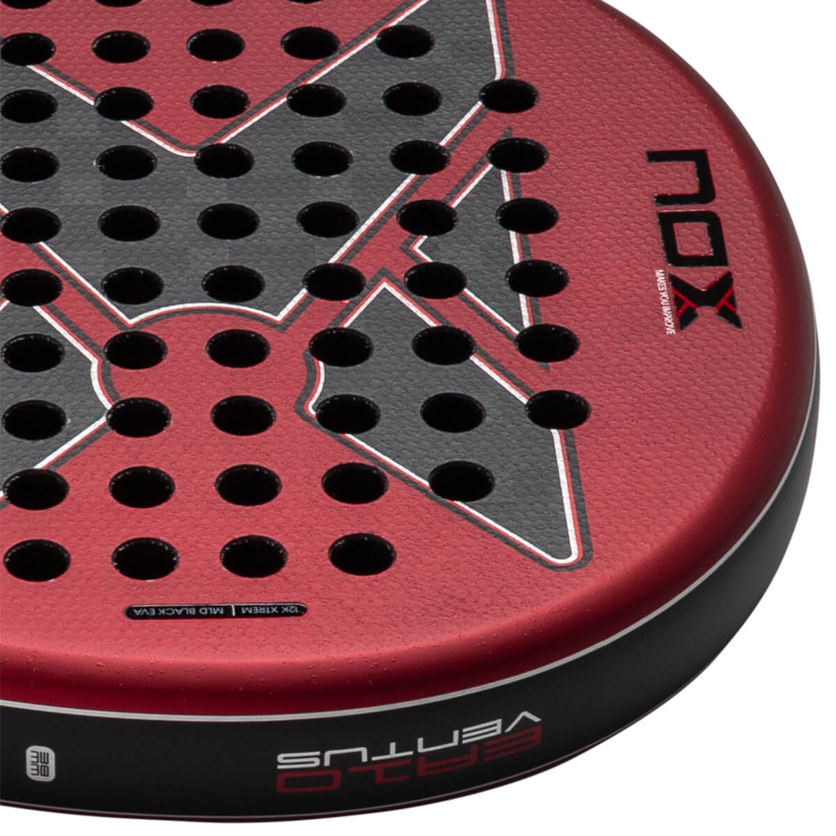 Close-up of the red and black textured padel racket face displaying the NOX and VENTUS logos, perforated holes, and 12K XTREM text along the rim.