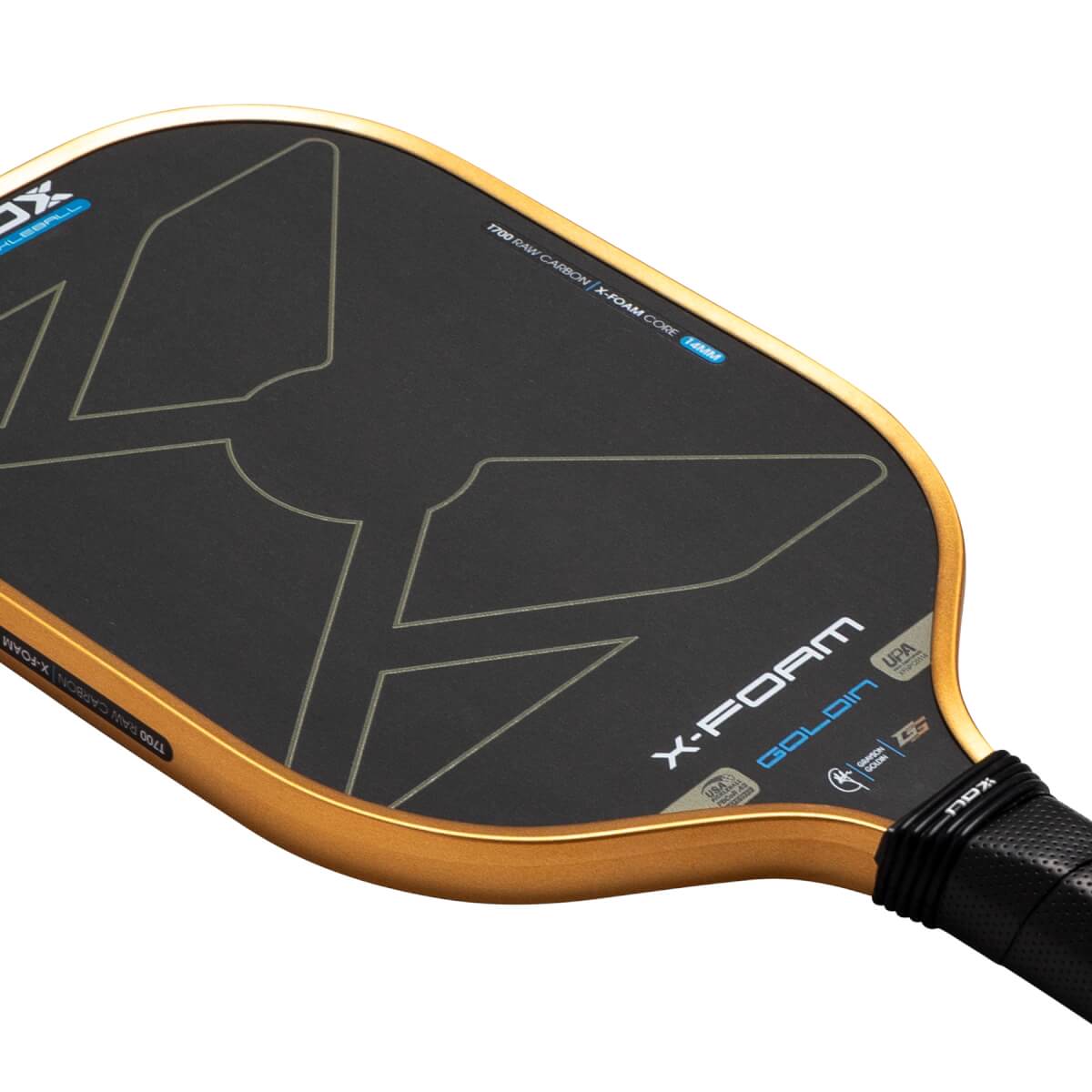 Angled close-up of the Nox X-Foam Goldin pickleball paddle featuring a black T700 raw carbon face with gold edges and prominent "X-FOAM GOLDIN" branding.