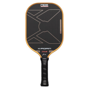 Front view of a Nox X-Foam JC6 paddle featuring a black face with gold trim, a large stylized X graphic, and prominent NOX, X-FOAM, and JC6 logos above the black grip.