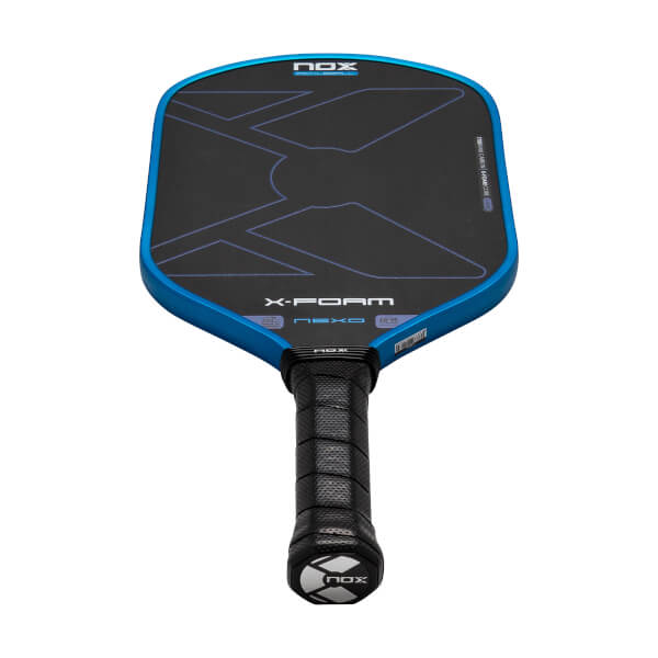 Front view of a blue-rimmed pickleball paddle featuring a black face with a large X design, a black perforated grip, and the words NOX, X-FOAM, and NEXO.