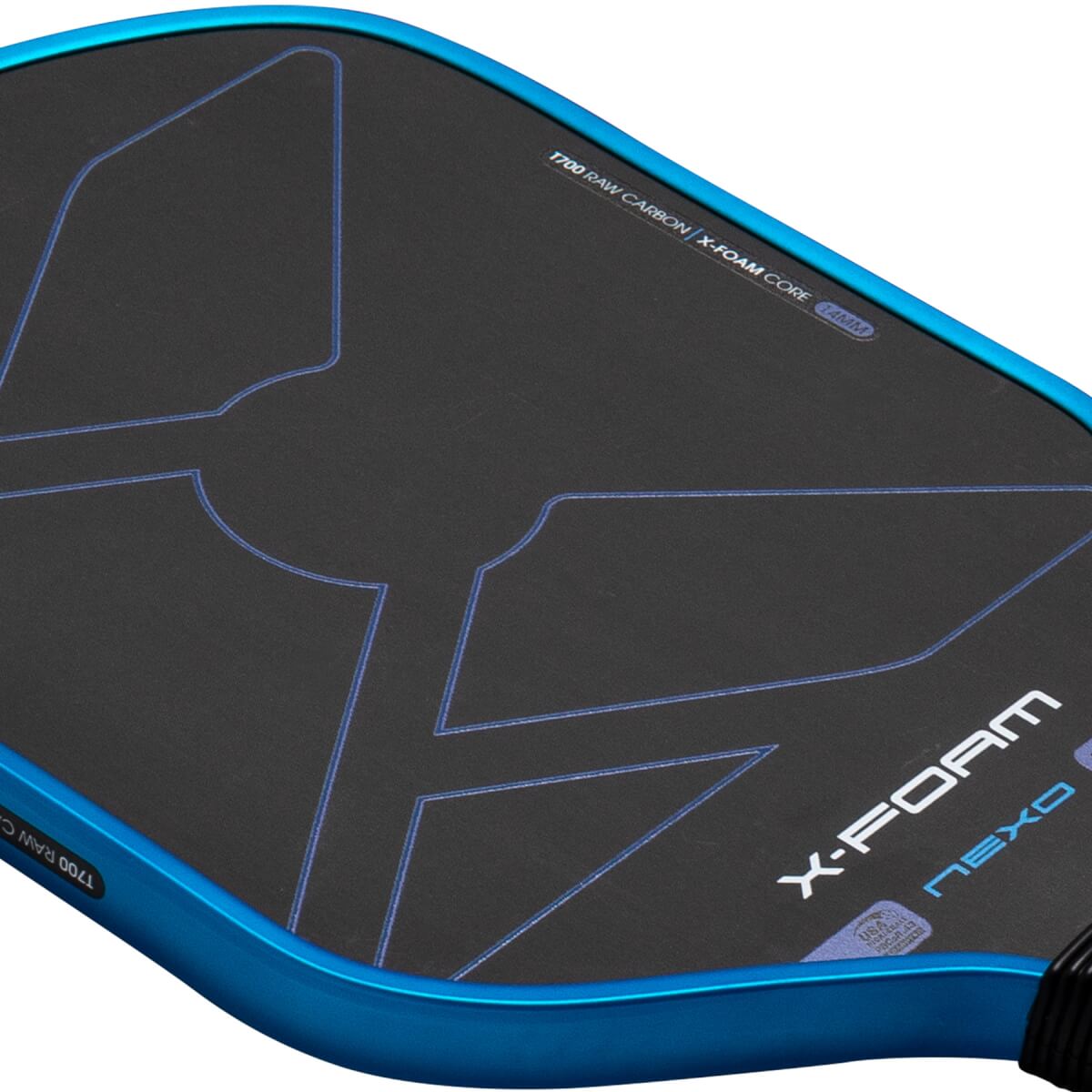 Close-up angled view of the paddle head showing its metallic blue rim, black textured face with blue geometric lines, and the words X-FOAM and NEXO.