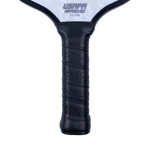 Close-up of a black pickleball paddle grip with perforations and USAPA APPROVED 12106 text.