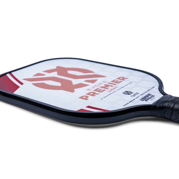Side view of a white pickleball paddle with red graphics, EVOKE PREMIER LIGHT text, and a black grip.