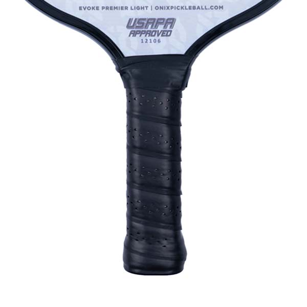 Close-up of a black pickleball paddle grip with perforated texture and USAPA approved stamp.