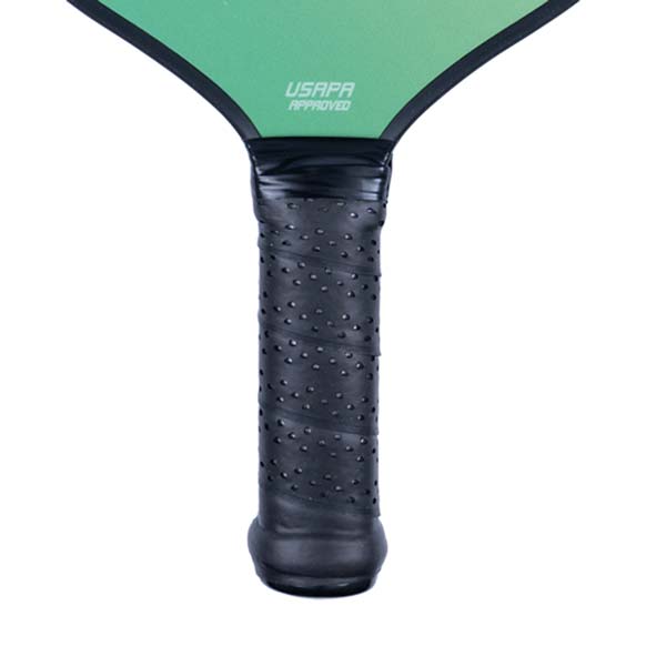 Close-up of a black pickleball paddle grip with perforated texture and USAPA APPROVED text.
