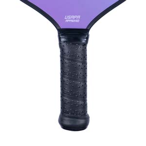 Close-up of a black pickleball paddle grip with USAPA APPROVED text on the purple head.