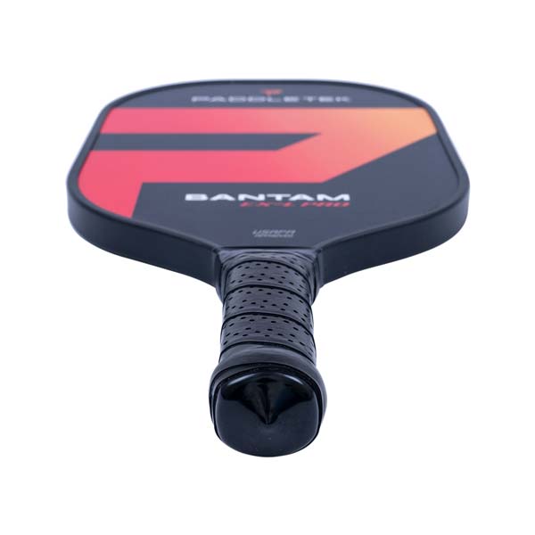 Top-down view of a black pickleball paddle with a red and orange graphic, BANTAM EX-L PRO text, and a perforated grip.