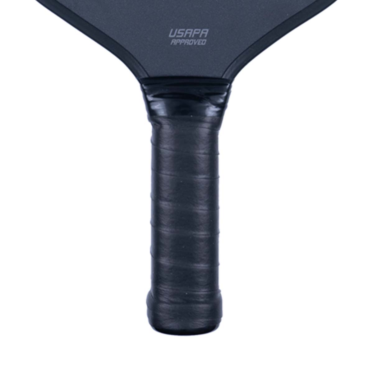 Close-up of a black pickleball paddle with USAPA APPROVED text and a textured grip.